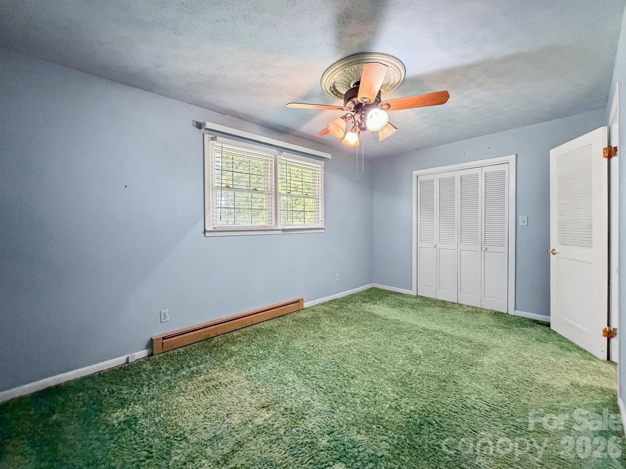 1401 East Union Street Morganton, NC 28655 - Photo 24 of 40 an empty room with windows and fan