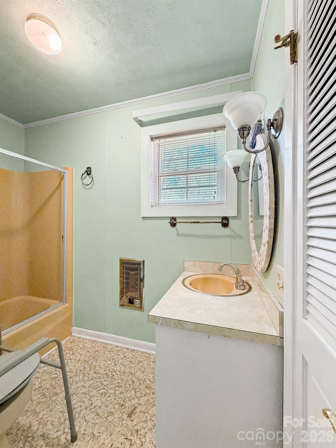 1401 East Union Street Morganton, NC 28655 - Photo 26 of 40 a bathroom with a sink a toilet and shower