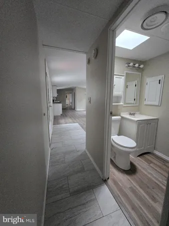 a bathroom with a toilet a sink and mirror