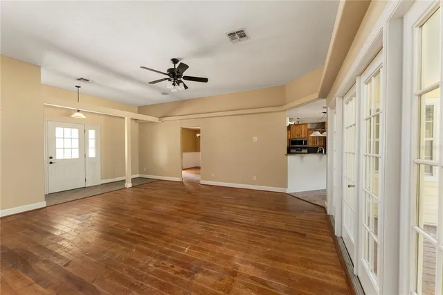 a view of a livingroom with a hardwood floor and a ceiling fan