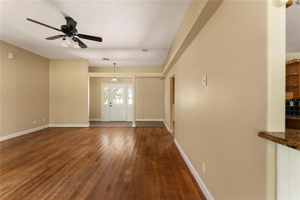 16017 Johns Lake Road Clermont, FL 34711 - Photo 12 of 62 a view of a livingroom with a hardwood floor and a ceiling fan