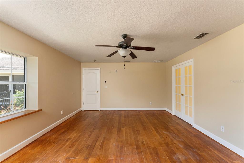 16017 Johns Lake Road Clermont, FL 34711 - Photo 21 of 62 a view of empty room with wooden floor and fan