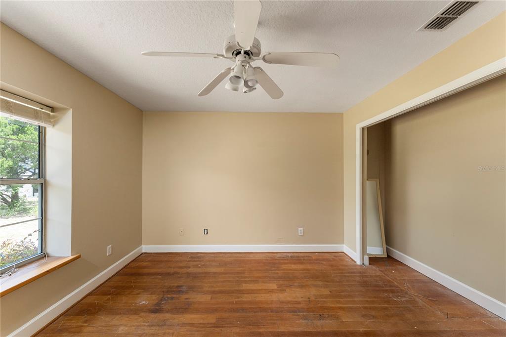 16017 Johns Lake Road Clermont, FL 34711 - Photo 26 of 62 a view of an empty room with wooden floor and a window