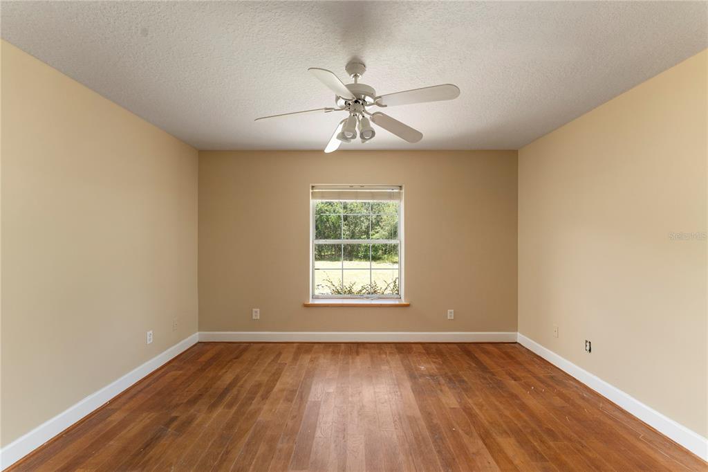 16017 Johns Lake Road Clermont, FL 34711 - Photo 27 of 62 an empty room with a window and a chandelier fan