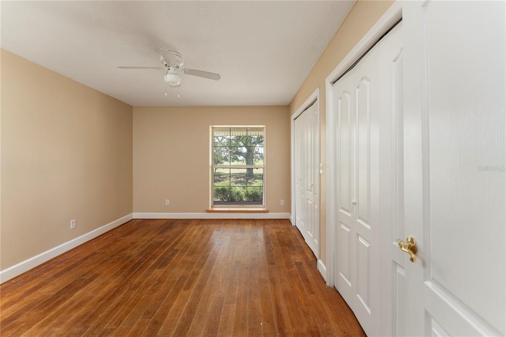 16017 Johns Lake Road Clermont, FL 34711 - Photo 28 of 62 a view of an empty room with wooden floor and a window