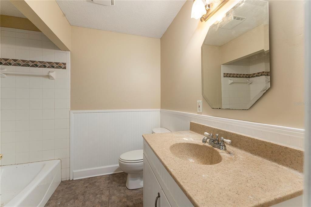 16017 Johns Lake Road Clermont, FL 34711 - Photo 30 of 62 a bathroom with a sink toilet and mirror