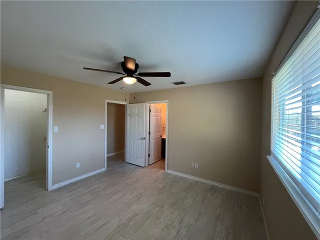 a bathroom with a tub a sink and a large mirror