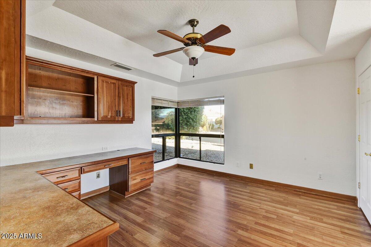 18445 East Flicker Drive Rio Verde, AZ 85263 - Photo 18 of 27 an empty room with wooden floor fan and windows