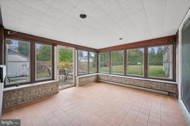 a view of a house with backyard sitting area and garden