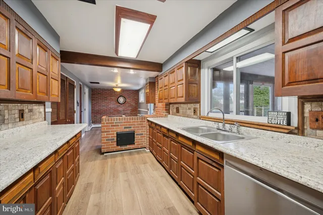 a large kitchen with a stove and large window