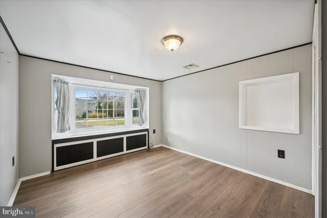 a view of workspace with window and wooden floor