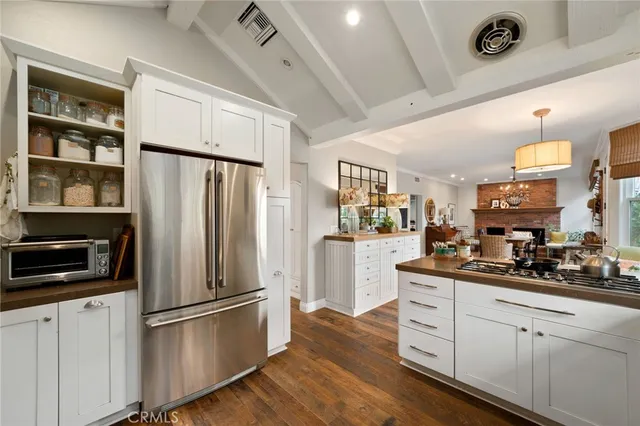 a kitchen with stainless steel appliances a refrigerator sink and cabinets