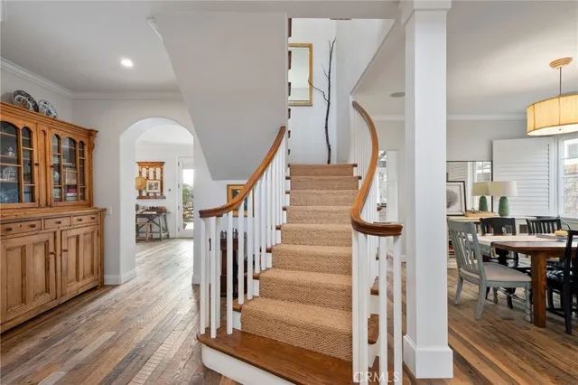 a view of front door with wooden floor and stairs