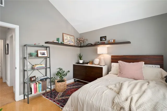 a bedroom with bed and cabinets