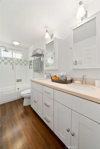 a spacious bathroom with a double vanity sink mirror and toilet