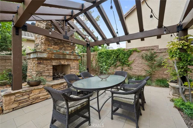 a backyard of a house with a table and chairs