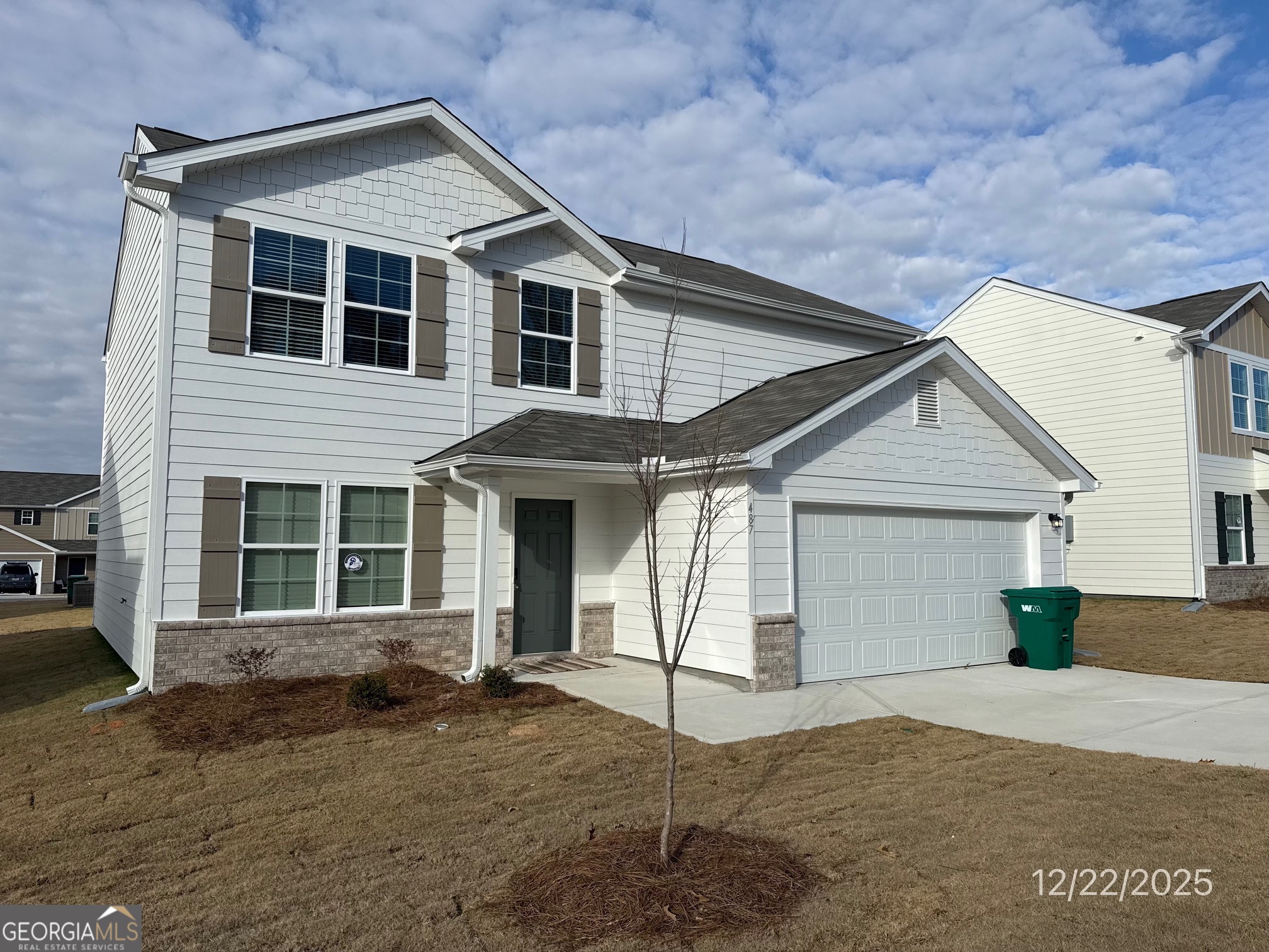 a view of a house with small yard and garage