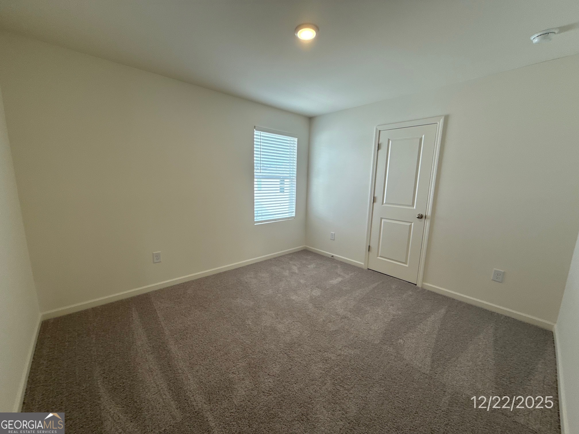 487 Grand Magnolia Street Jackson, GA 30233 - Photo 11 of 18 an empty room with windows