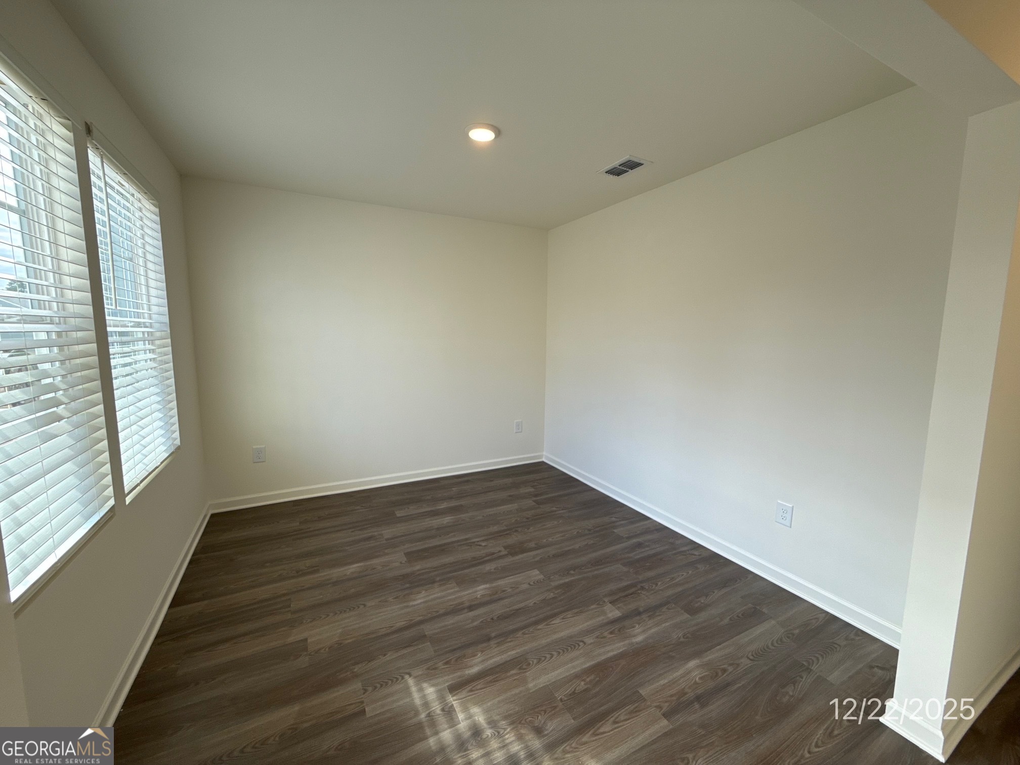 487 Grand Magnolia Street Jackson, GA 30233 - Photo 2 of 18 a view of an empty room with wooden floor and a window