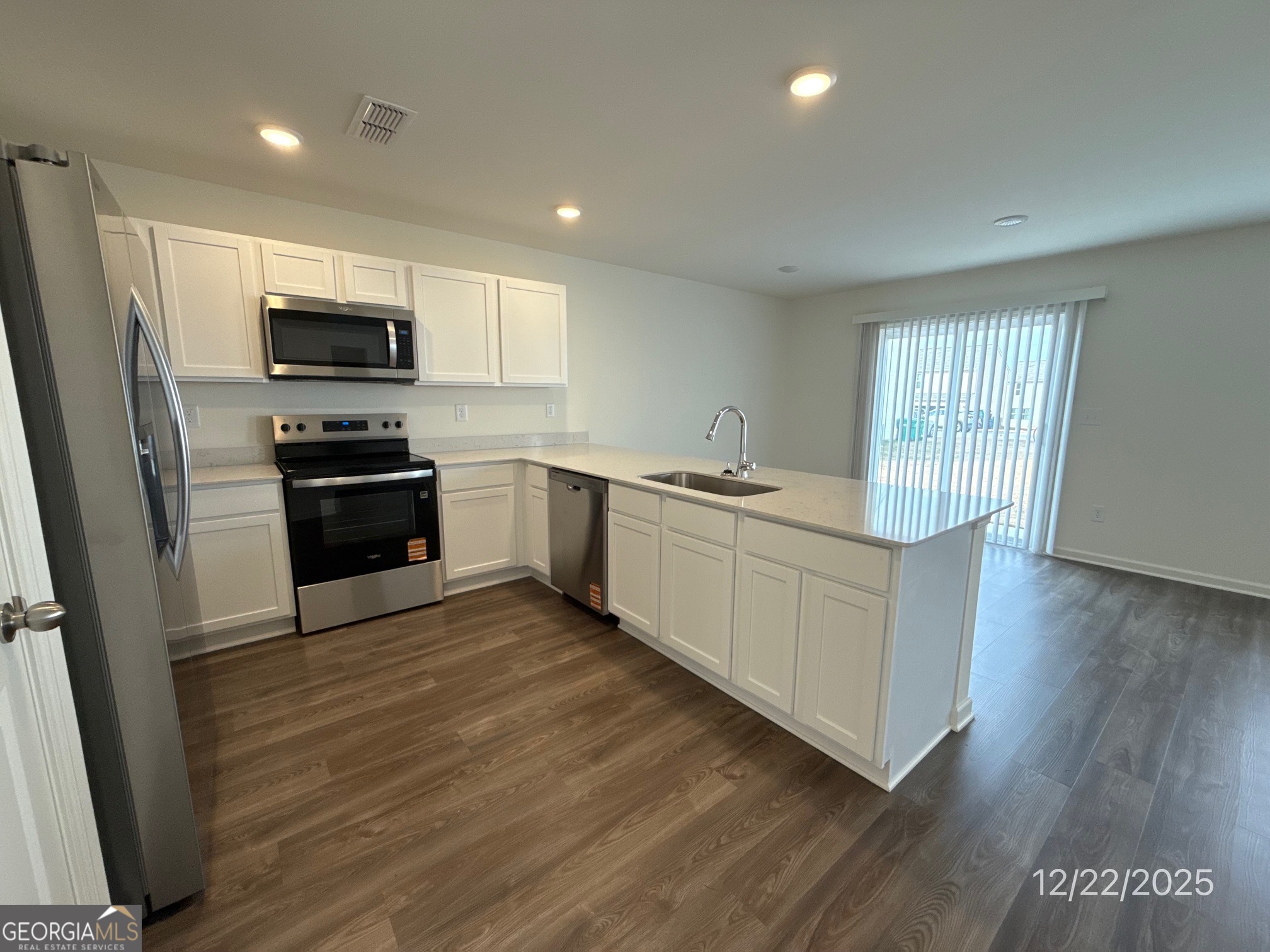487 Grand Magnolia Street Jackson, GA 30233 - Photo 3 of 18 a kitchen with stainless steel appliances granite countertop a stove a sink and a refrigerator