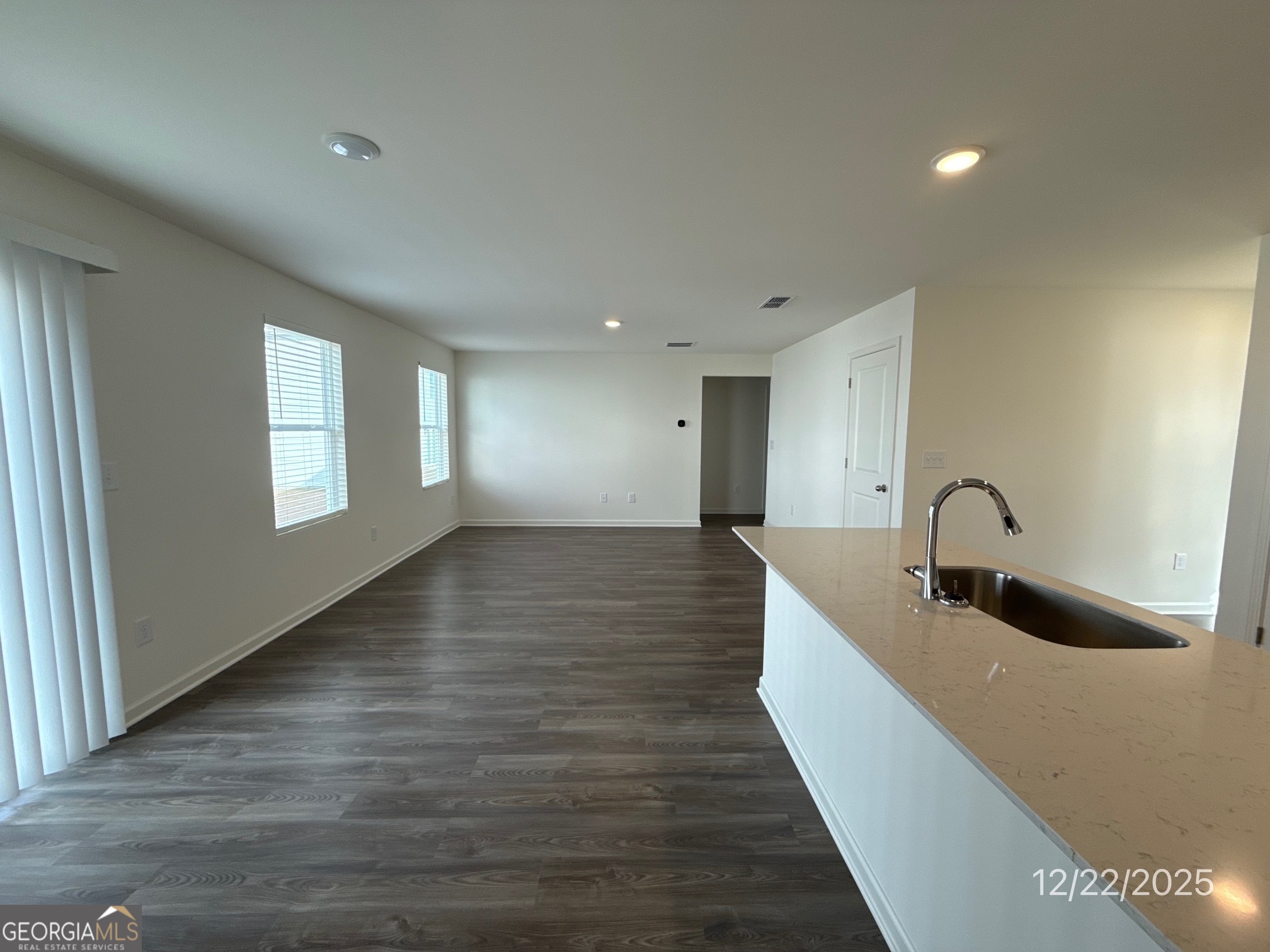 487 Grand Magnolia Street Jackson, GA 30233 - Photo 4 of 18 a hall with a sink and natural light