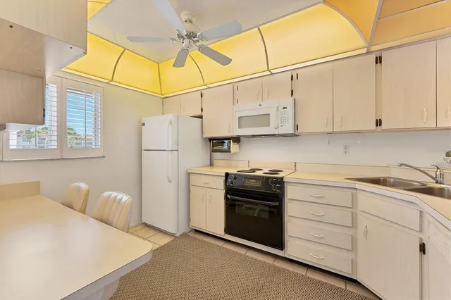 a spacious bedroom with a bed and a chandelier