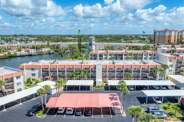 a view of a hallway with wooden floor and a living room