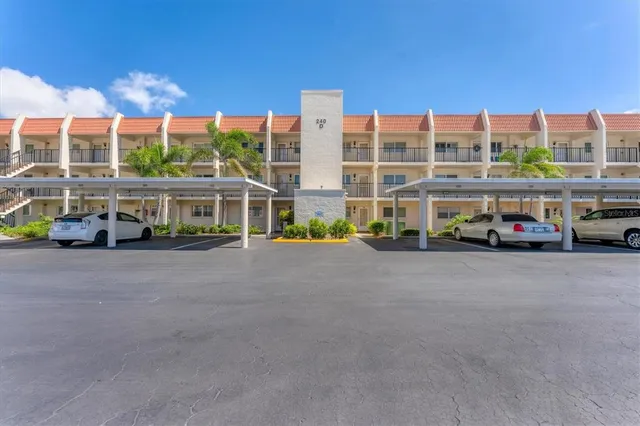 a view of a hallway with wooden floor and a kitchen