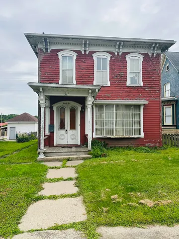 a front view of a house with a garden