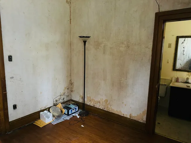 a room with a table and a fireplace