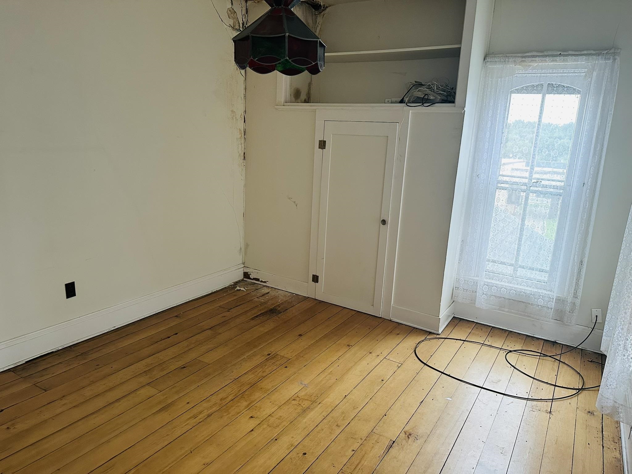 35 3rd Street Savanna, IL 61074 - Photo 18 of 20 a view of a room with wooden floor and a shower
