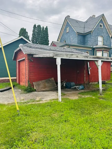 a front view of house with yard and garage