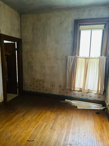 a view of a room with wooden floor and chair