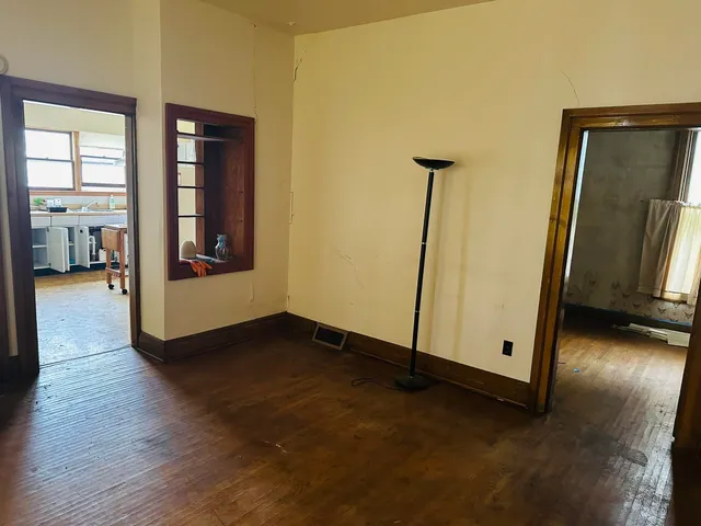 a view of a room with wooden floor