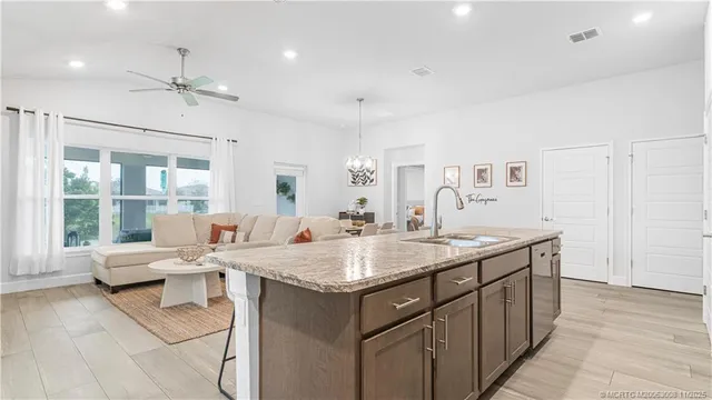 a front view of a house with a garden and trees