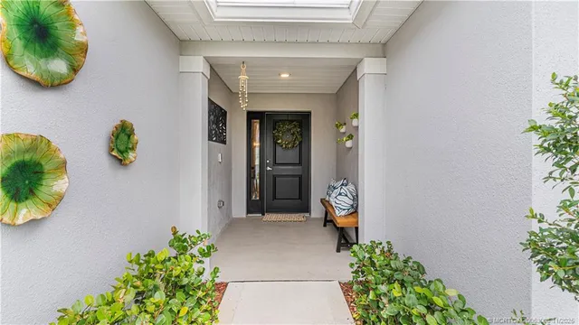 a living room with stainless steel appliances kitchen island granite countertop furniture and a wooden floor