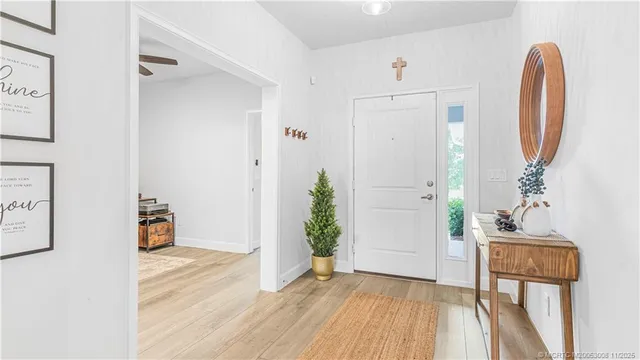 a living room with furniture a flat screen tv and a large window