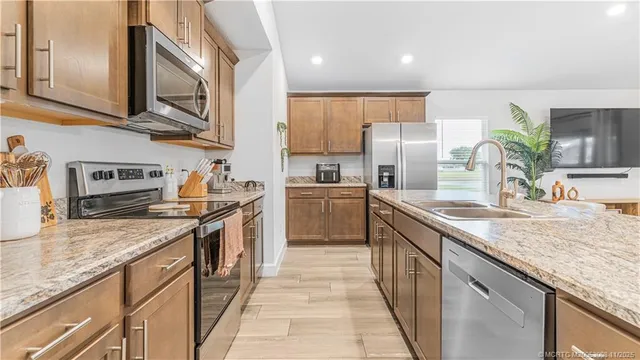 a en suite bathroom with a granite countertop sink and a mirror