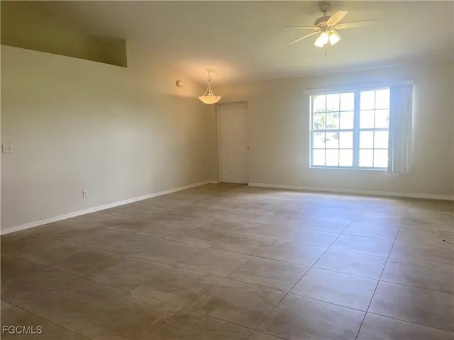 an empty room with windows and entrance