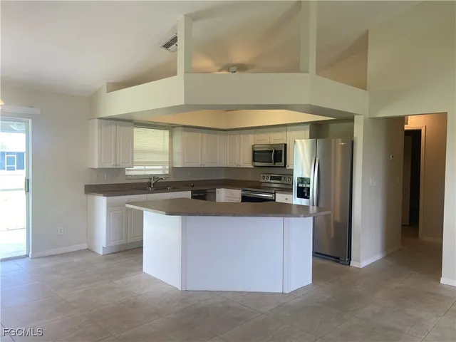 a kitchen with stainless steel appliances granite countertop a sink and a stove