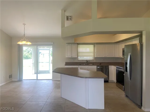 a kitchen with a refrigerator and a sink