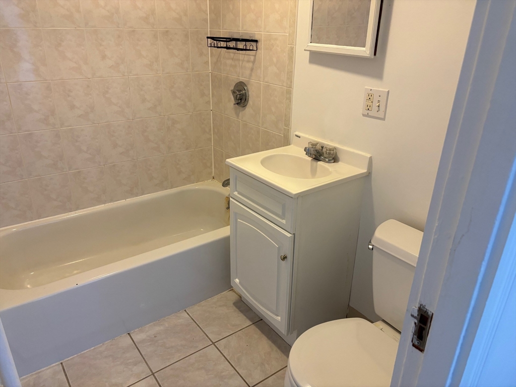 117 Summer Street, Unit 28 Malden, MA 02148 - Photo 6 of 6 a bathroom with a sink a toilet and shower