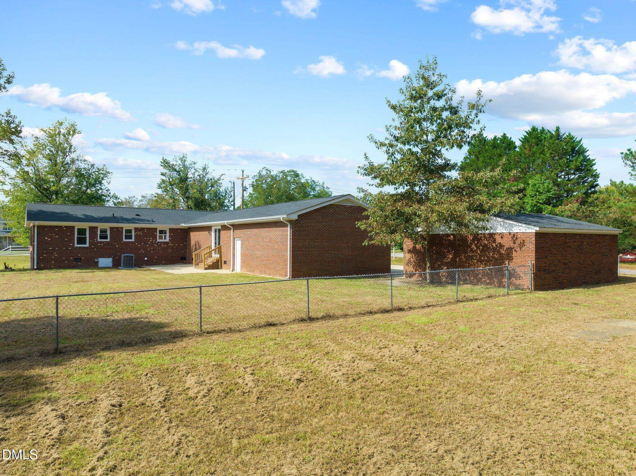 6501 Rock Service Station Road Raleigh, NC 27603 - Photo 12 of 49 a house view with a swimming pool next to a yard