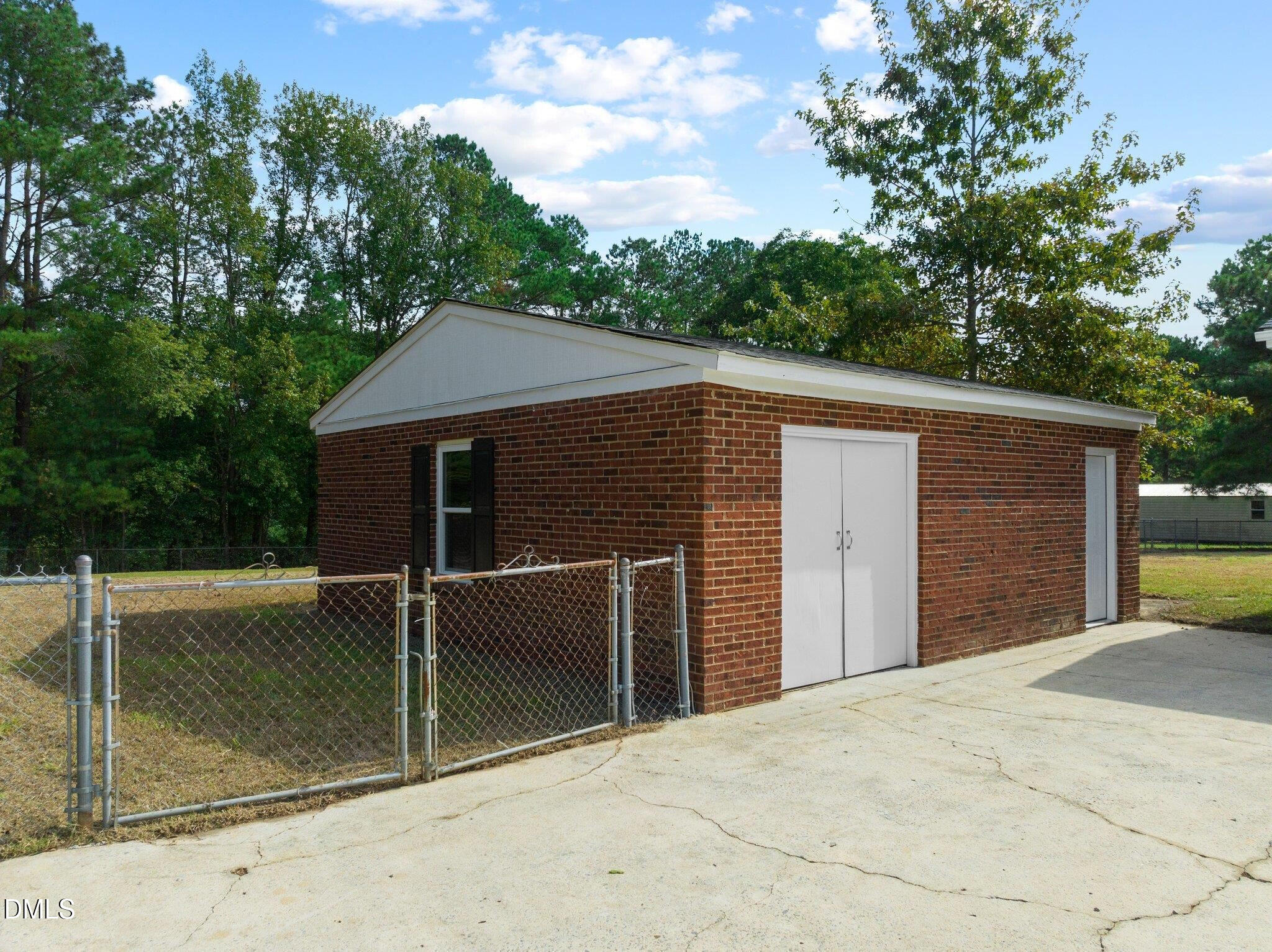6501 Rock Service Station Road Raleigh, NC 27603 - Photo 17 of 49 a front view of a house with a garage
