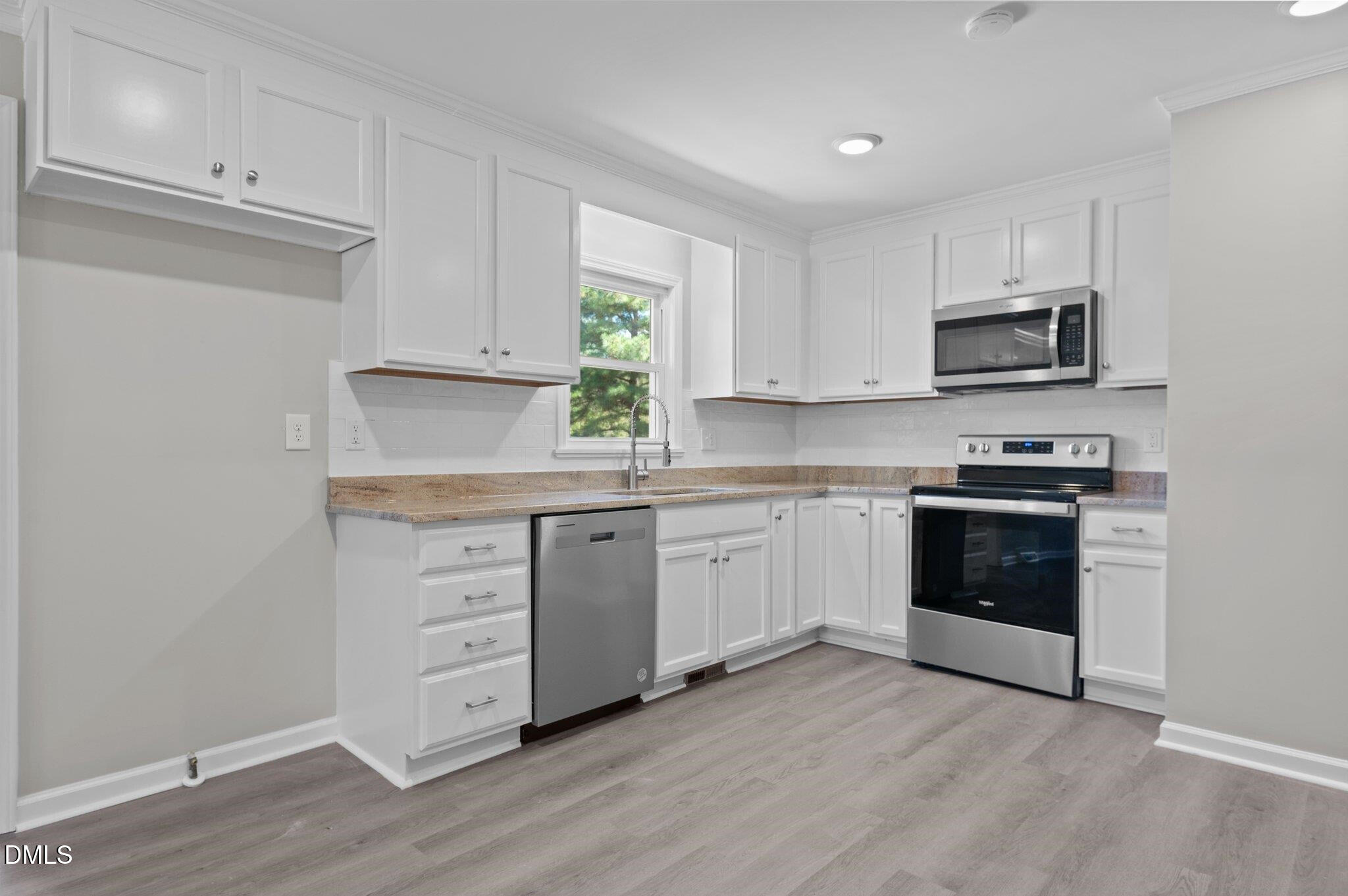 6501 Rock Service Station Road Raleigh, NC 27603 - Photo 27 of 49 a kitchen with granite countertop white cabinets and stainless steel appliances