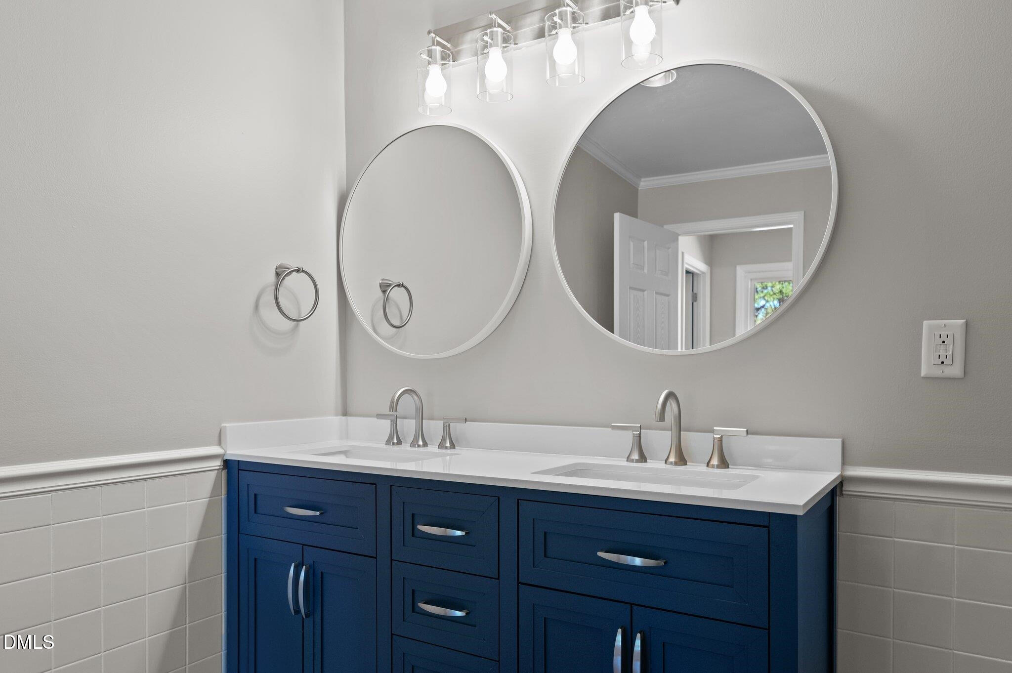 6501 Rock Service Station Road Raleigh, NC 27603 - Photo 39 of 49 a bathroom with a double vanity sink and a mirror