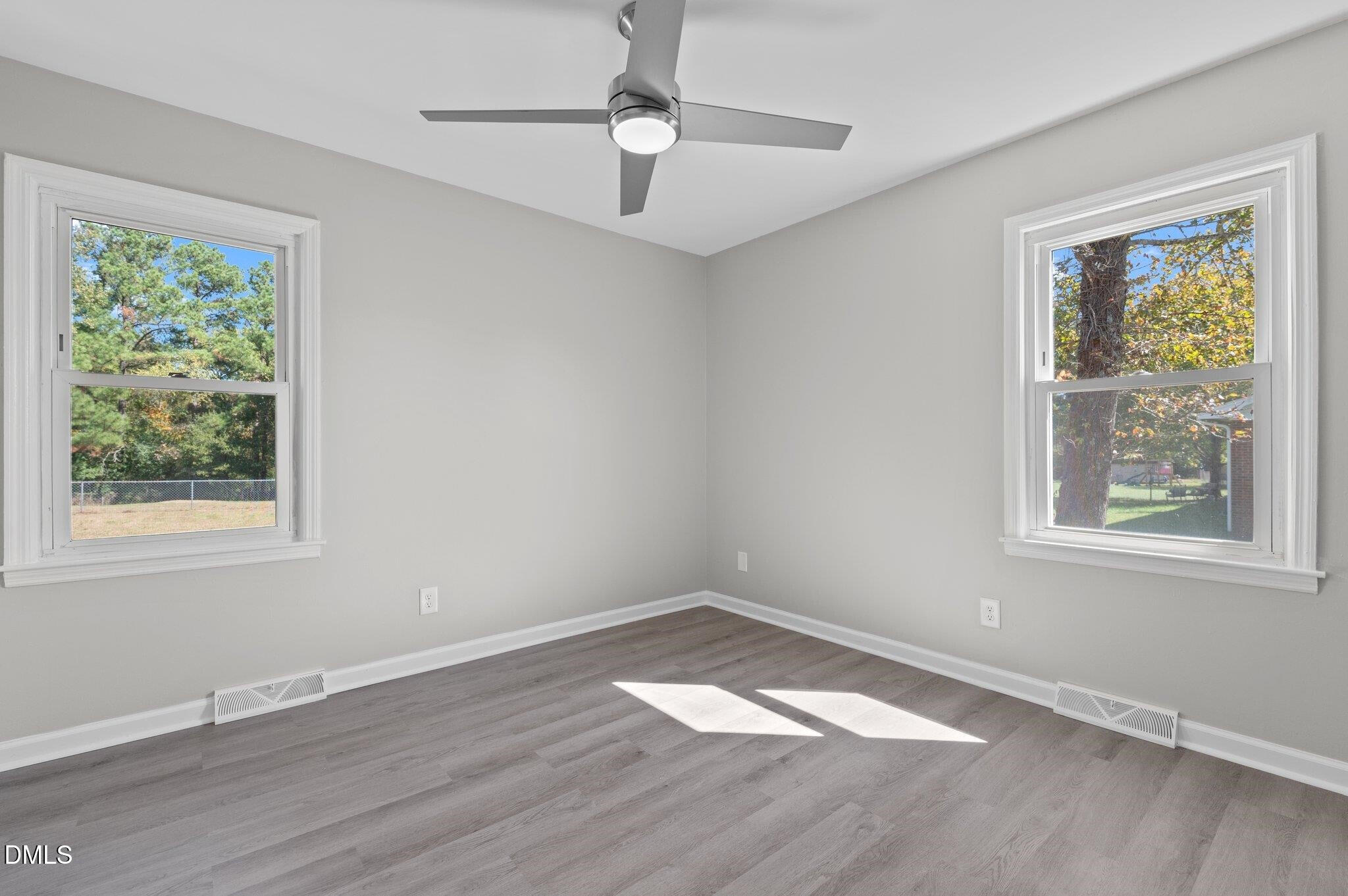 6501 Rock Service Station Road Raleigh, NC 27603 - Photo 45 of 49 a view of empty room with wooden floor and fan