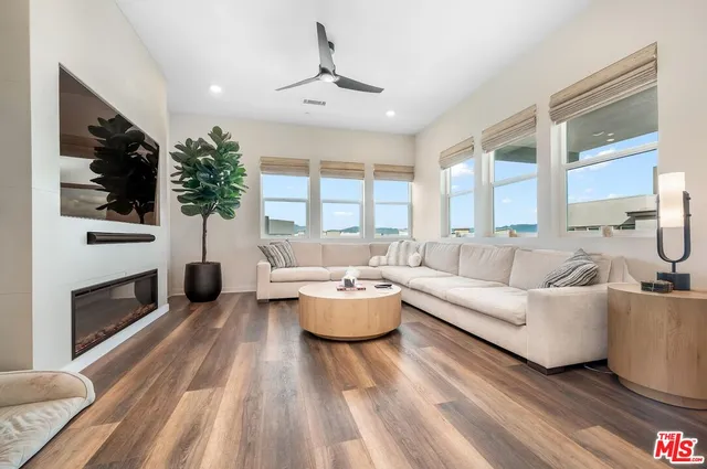 a large kitchen with a lot of counter space and wooden floor
