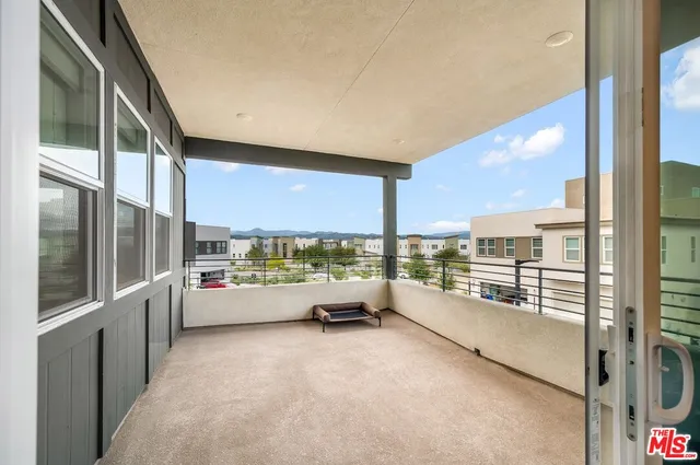 a bedroom with a bed a window and a chandelier
