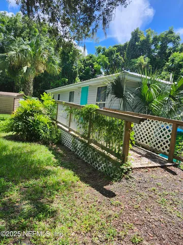 a view of a garden with wooden fence